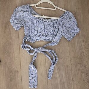 this light blue and white floral top is a XS from Hollister.